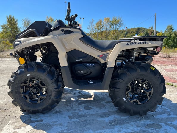2023 Can-Am Outlander parked on cement - side angle view