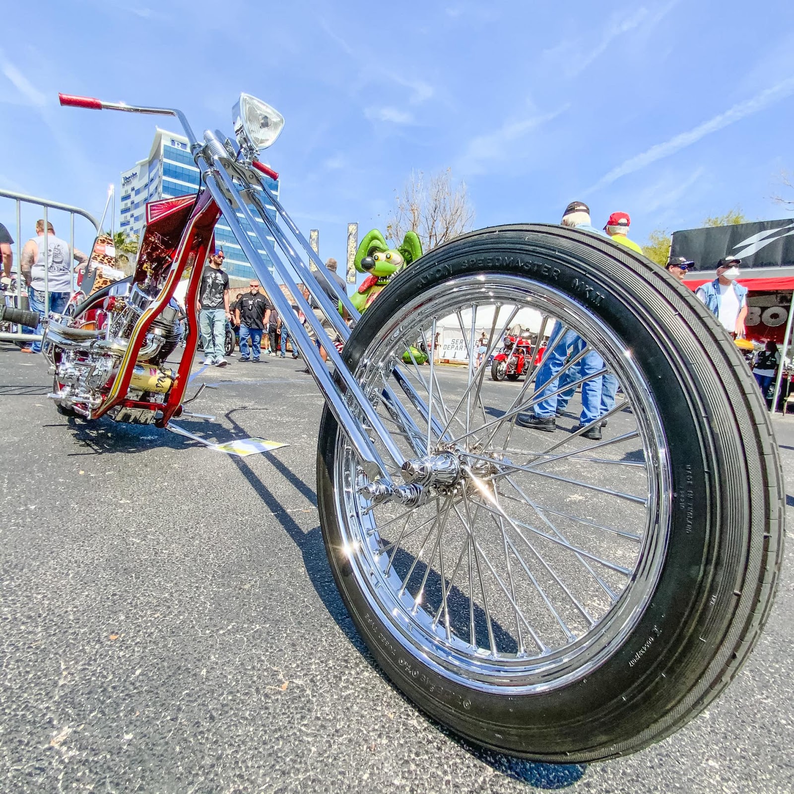 A zoomed in picture of a motorcycle wheel, completely upgraded and customized to look like a low rider chopper chromed out wheel.