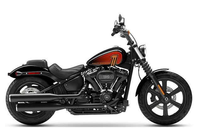 All-black 2023 Harley-Davidson Street Bob with red and orange accents in a showroom.