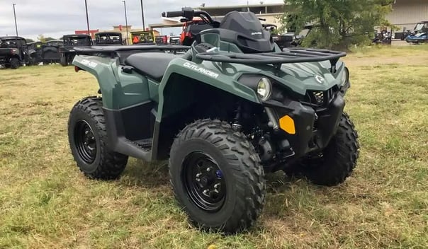 Green 2021 Can-Am Outlander 450 parked on grassy terrain