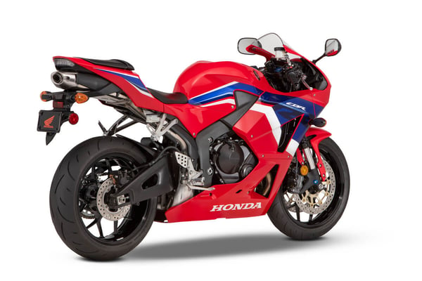 Red 2023 Honda CBR600RR street bike parked in a display room 