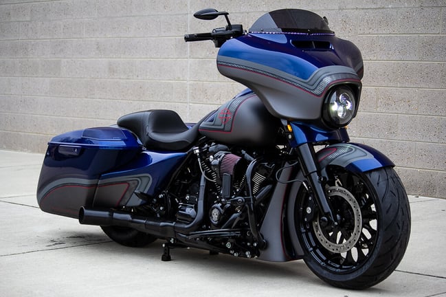 Royal Blue Harley Davidson Street Glide parked on sidewalk - Iconic motorcycle for cruising enthusiasts