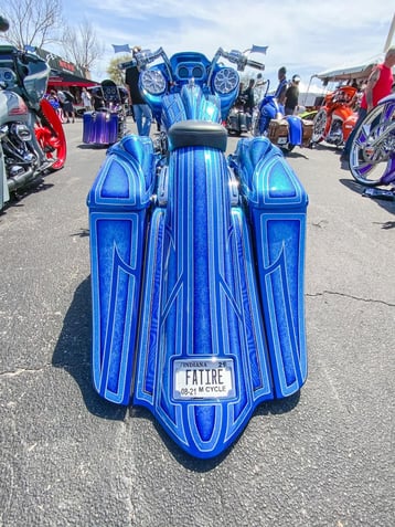 The rear of a motorcycle bagger completely pinstriped in bright blue detailing.-2