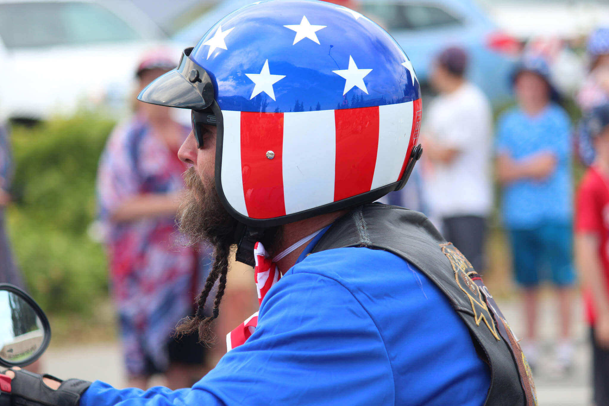 Motorcycle rider wearing the best patriotic helmet with American flag design, celebrating Fourth of July