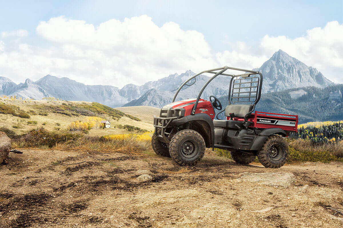 A 2023 Kawasaki Mule SX, the cheapest side-by-side UTV, parked on a dirt terrain
