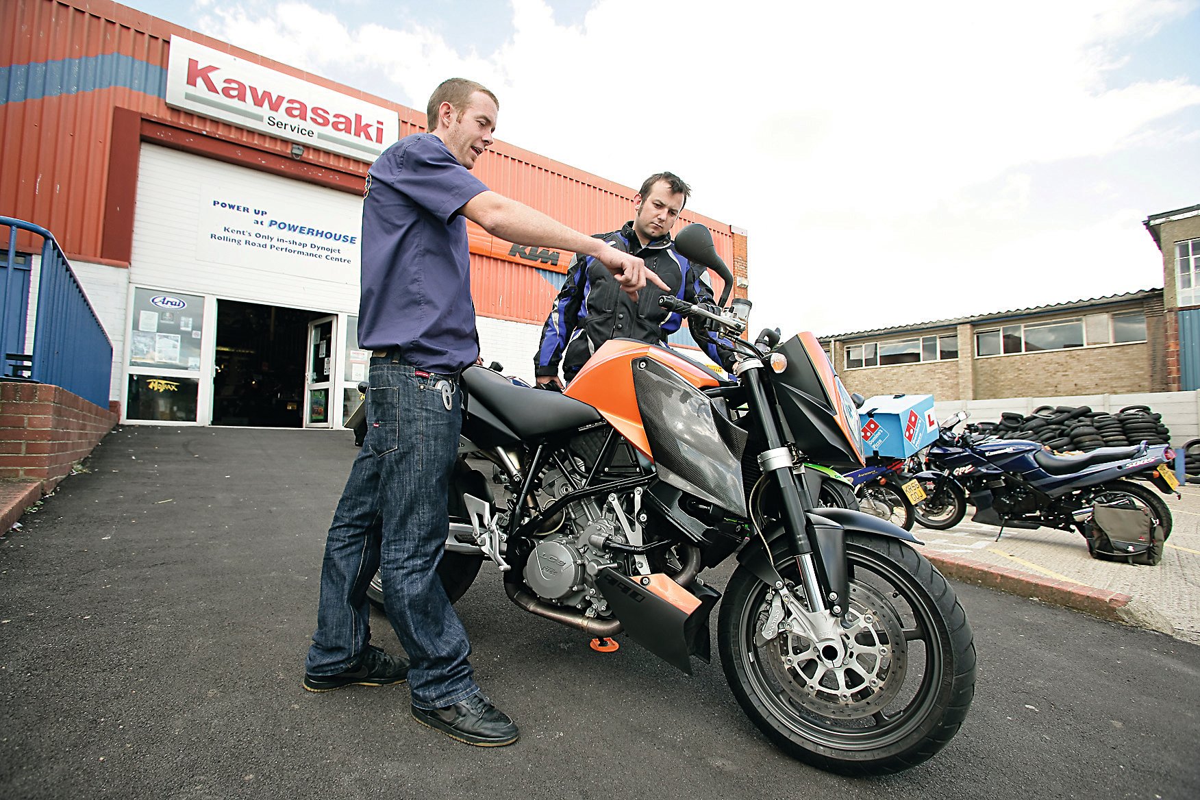 Motorcyclist inspects bike for sale