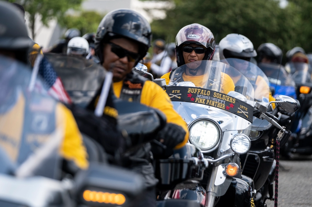 Members of the Buffalo Soldiers, a Black biker club, riding motorcycles in a Juneteenth parade