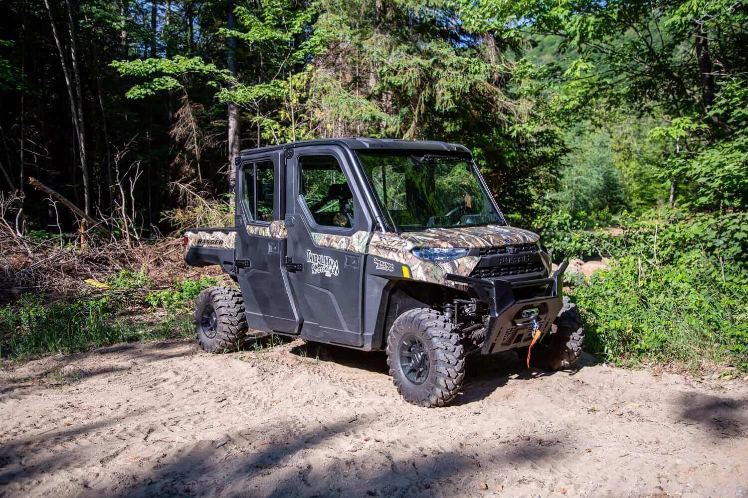 Camo Polaris Ranger Crew XP 1000 in forest, demonstrating why it's the best side by side vehicle