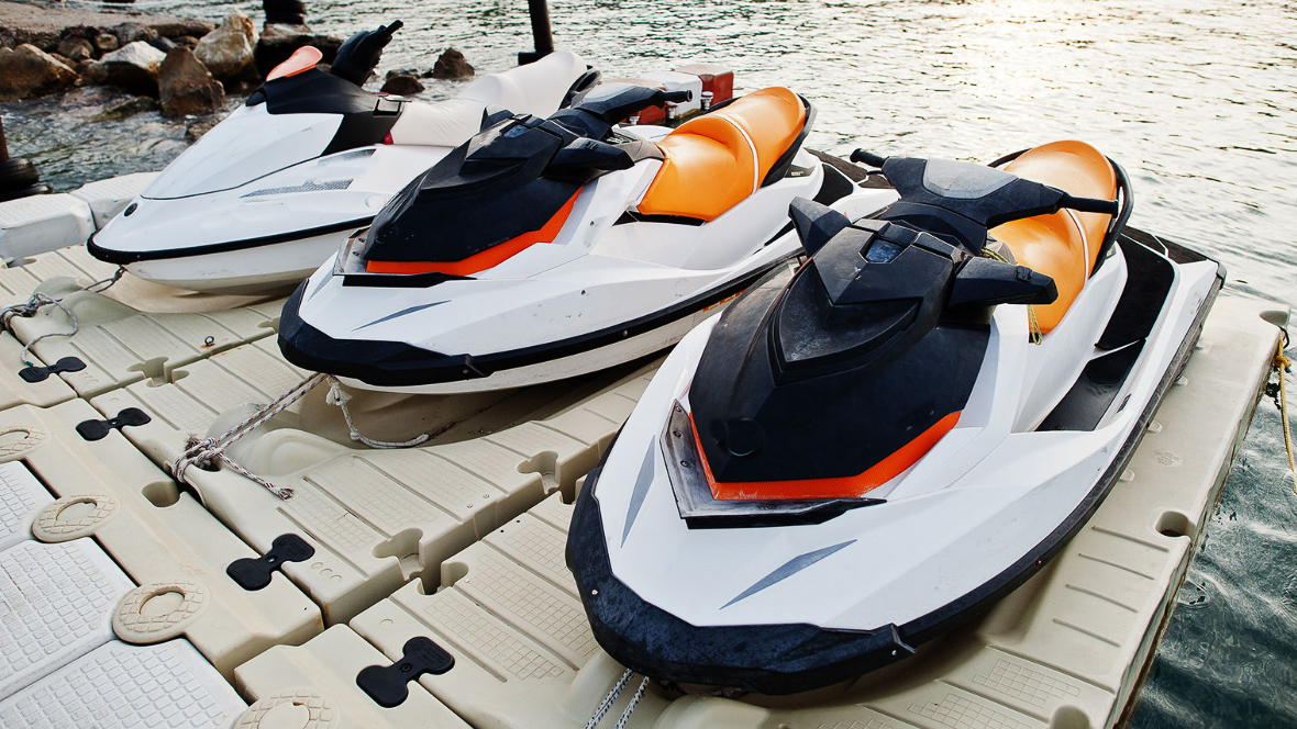 Preparing for winter: Three jetskis on loading dock for servicing