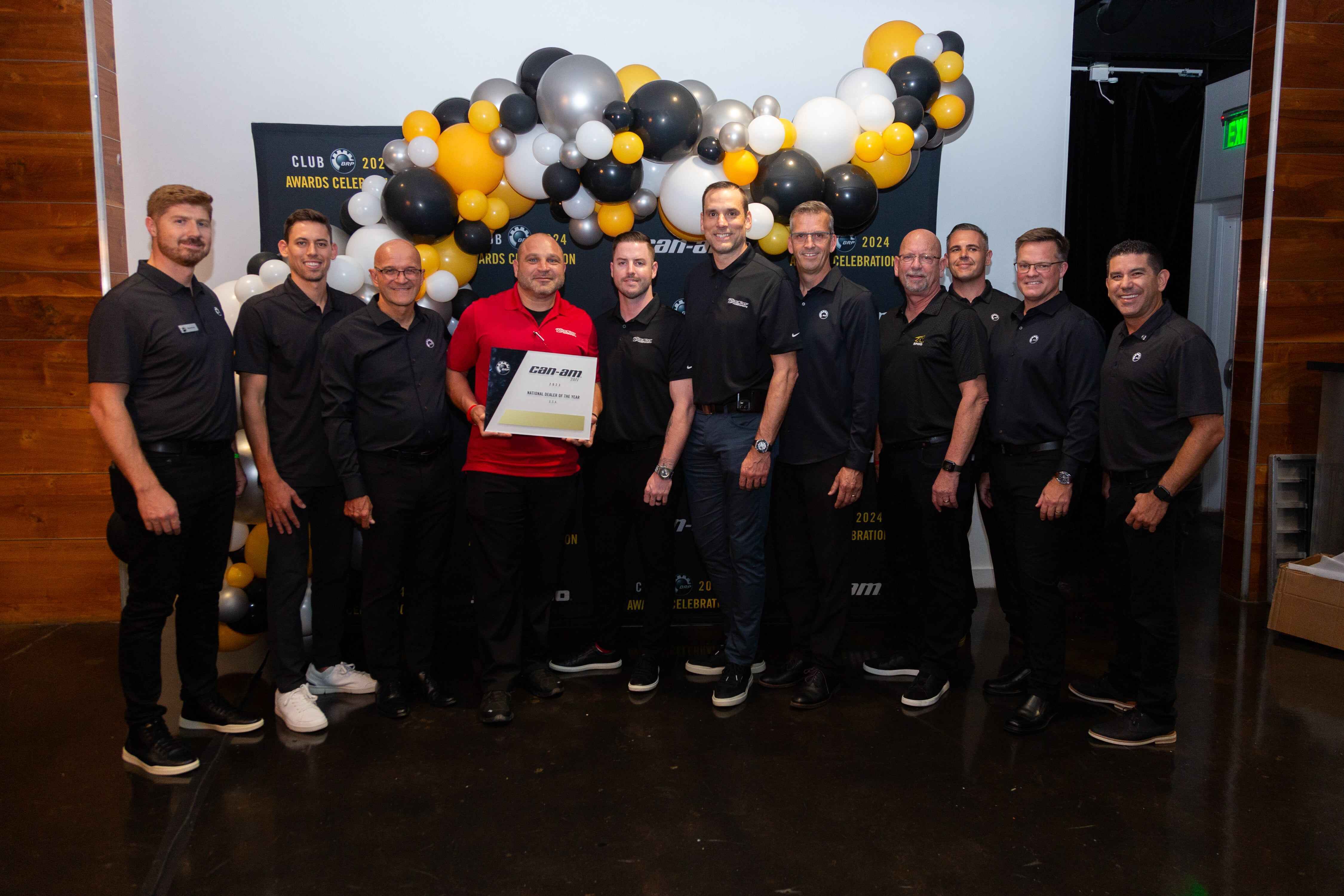 RideNow Chandler team holding Can-Am 2023 Dealer of the Year award with smiles
