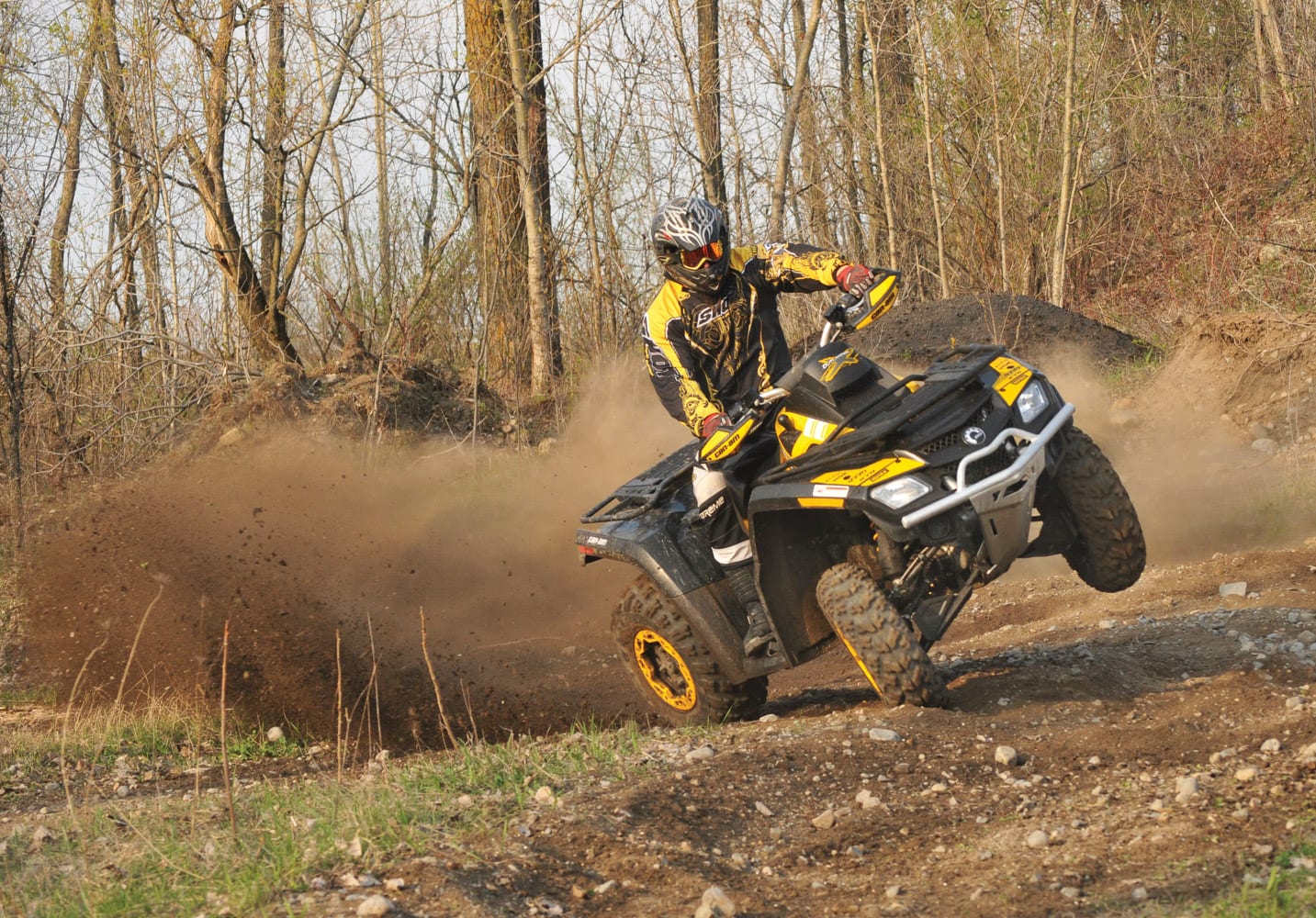 Experienced rider with proper safety gear conquering a challenging motocross trail on two wheels