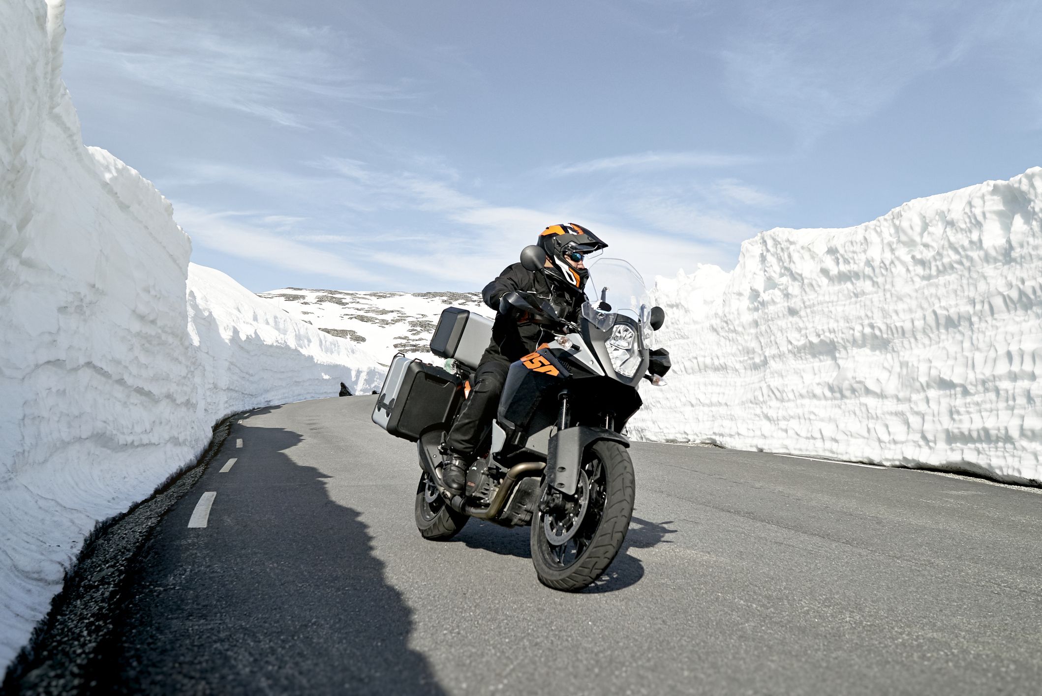 Feel the adrenaline rush as a motorcyclist speeds through a snow-cleared highway on a powerful bike
