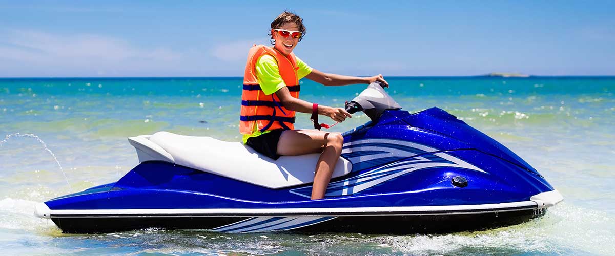 Teen riding jet ski on water