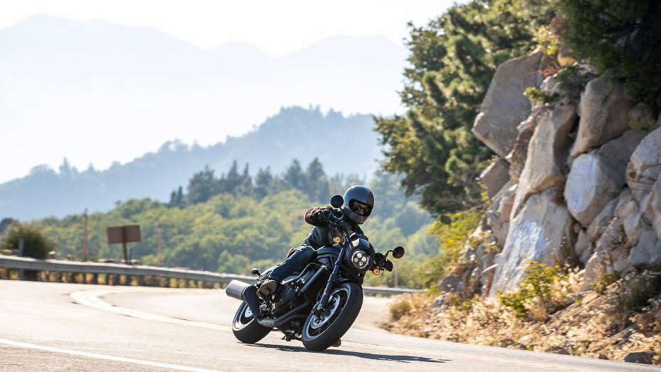 A motorcyclist approaching a curve on a mountain rode, while riding a 2021 Honda Rebel 1100. 