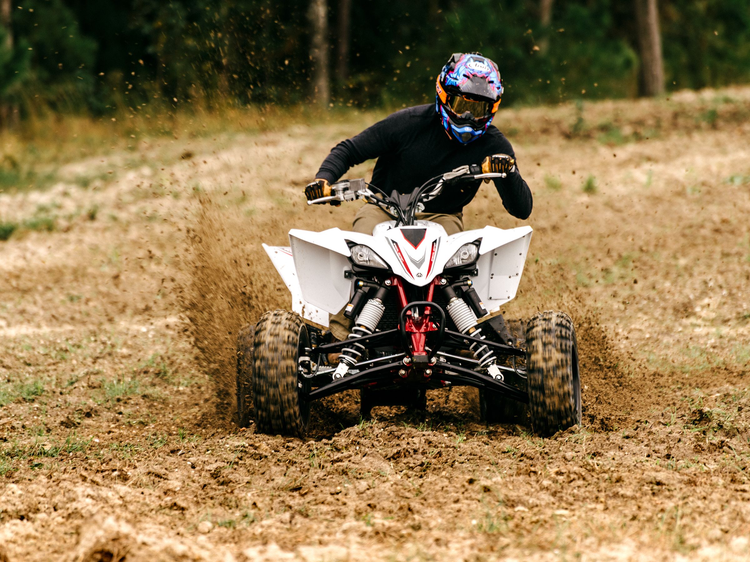 Sport ATV throwing mud on track, an adrenaline-fueled ride for off-road enthusiasts